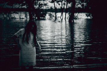 Portrait of asian woman make up ghost face at the swamp,Horror in water scene,Scary at...