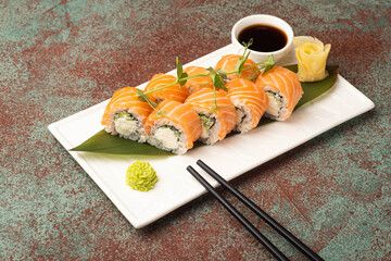 Sushi, rolls, sushi with fish on a textured background, side view