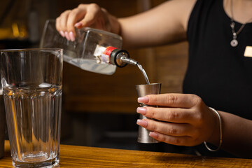 A bartender prepares a cocktail at the restaurant bar
