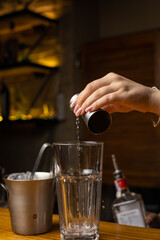A bartender prepares a cocktail at the restaurant bar
