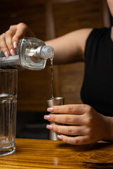 A bartender prepares a cocktail at the restaurant bar
