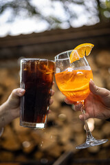 The girl tastes a cocktail at the restaurant bar

