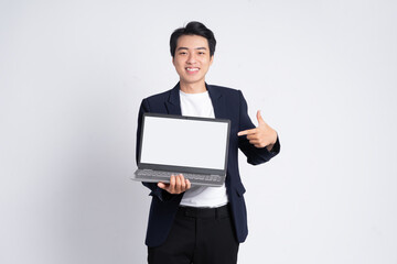 Young business man wearing a suit posing on a white background