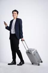 Young business man wearing a suit posing on a white background