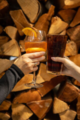 The girl tastes a cocktail at the restaurant bar
