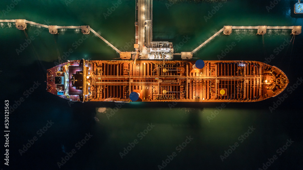 Canvas Prints aerial top view oil tanker ship at terminal industrial port at night for transfer crude oil to oil r