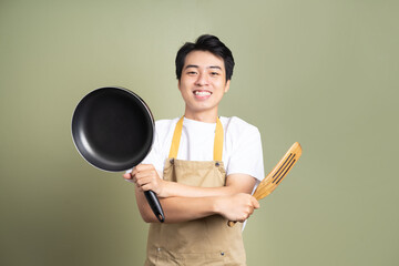 man holding a pan on the background
