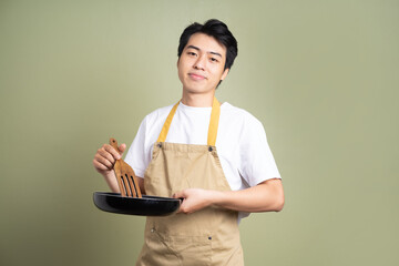 man holding a pan on the background