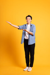 Fototapeta na wymiar full body image of asian man posing on yellow background