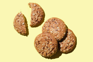 Dietary oatmeal cookies with  seeds on yellow background.