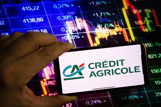 KONSKIE, POLAND - September 10, 2022: Smartphone displaying logo of Credit Agricole company on stock exchange chart background