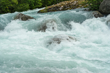 Blue spring water stream, Norway, Briksdal. National park Jostedalsbreen.