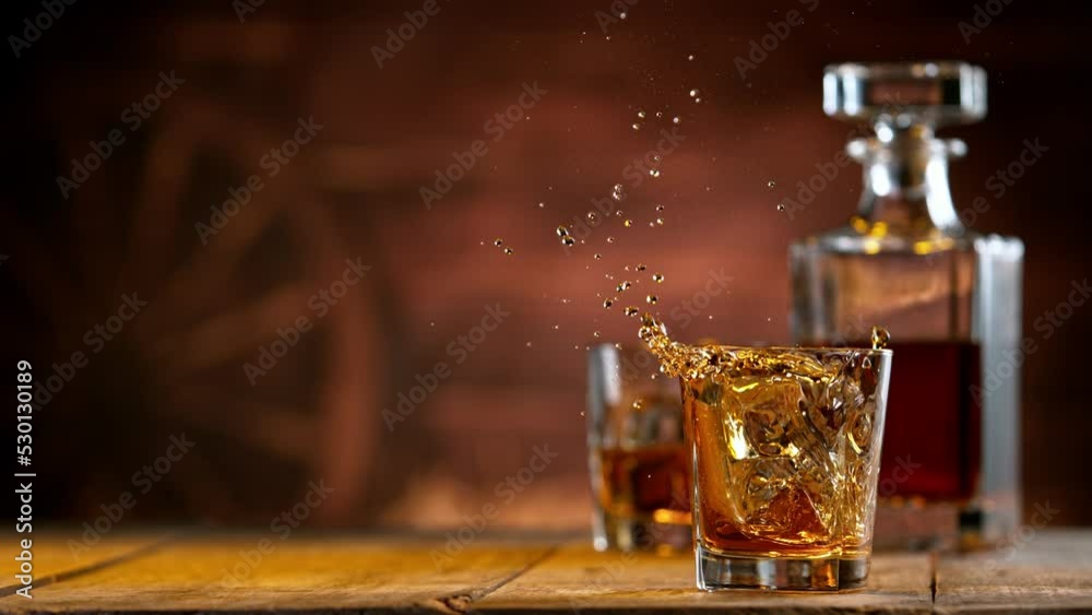 Aufkleber super slow motion of falling ice cube into whiskey. speed ramp effect. filmed on high speed cinema c