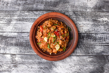 Pilaf with meat, vegetables, chicken. homemade pilaf on a white wooden background