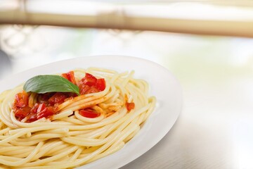 Traditional Italian pasta dish with tomatoes in the plate