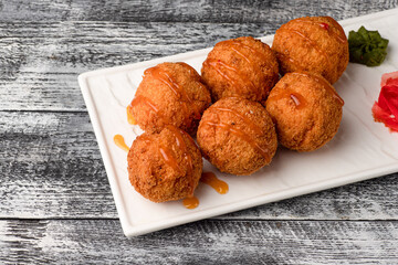 Cheese balls, beer appetizer on a white wooden background