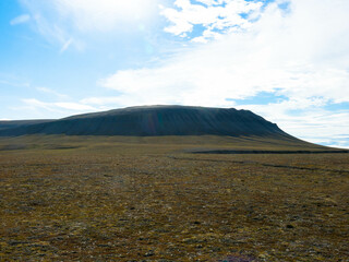 Snowless arctic landscape. Seen on Barentsoya island. Spitsbergen, Svalbard, Norway. Tourism and vacation concept.