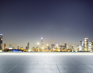 Empty concrete rooftop on the background of a beautiful blurry Chicago city skyline at twilight, mockup