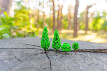 Tree stump with toy trees outdoors
