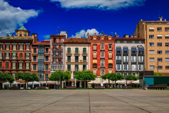 Ornate facades of buildings on Historic Plaza del Castillo with restaurants and cafes in Old Town Pamplona, Spain famous for running of the bulls