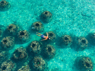 Fototapeta premium Man Snorkelling in the Sea. High quality photo. Aerial View from above.