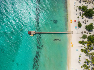 Obraz na płótnie Canvas Tropical Beach View from above with sandy beach and pier