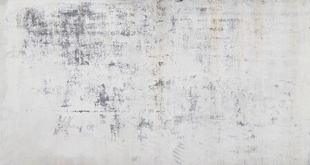 Front view of a weathered, aged and dirty wall, white plastered and painted surface peeling off. Abstract high resolution full frame textured background.