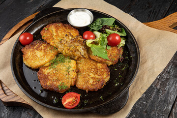 delicious potato fritters on a wooden table
