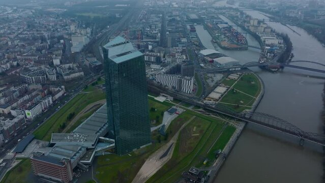 Elevated shot of futuristic European Central Bank skyscraper. bridge over river in city and harbour in background. Frankfurt am Main, Germany