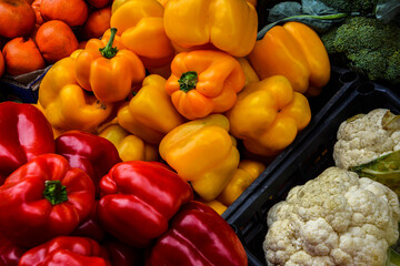 Red, yellow and green Bell Peppers .