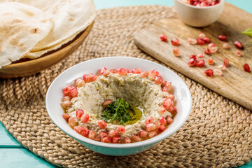 Mutable with pita bread served in dish isolated on wooden table side view of middle eastern food