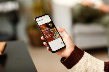 Close-up of woman using her mobile phone to order food online