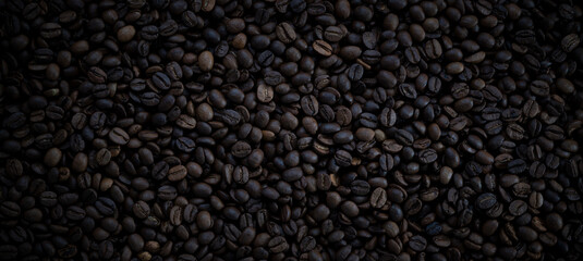 Panoramic close-up texture of coffee beans. Hot drink background