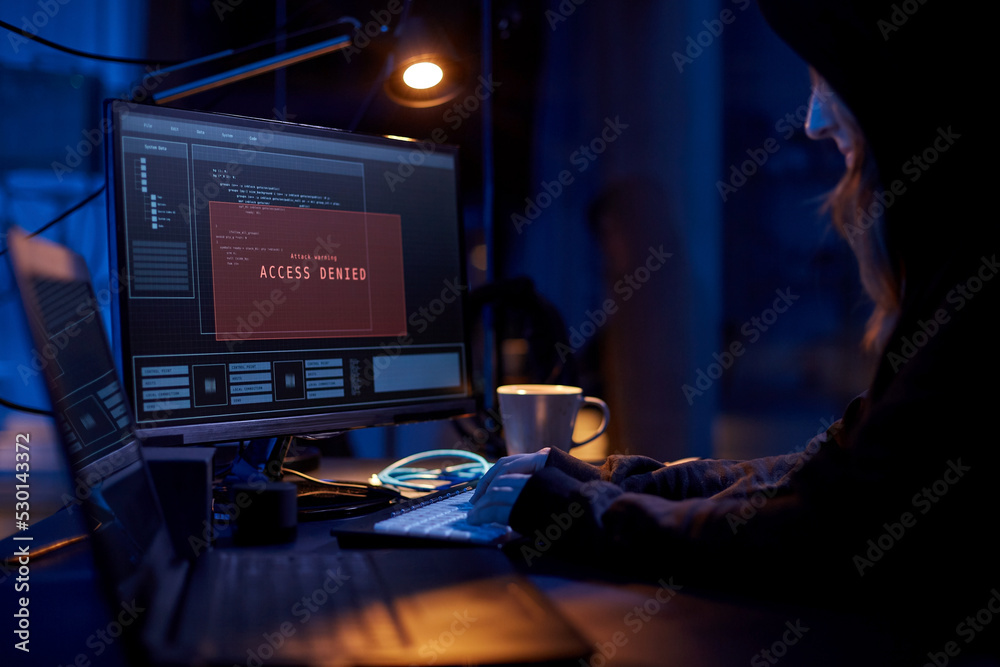 Poster cybercrime, hacking and technology concept - close up of female hacker in dark room breaking securit