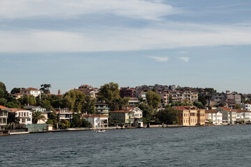Fototapeta na wymiar View of historical, traditional mansions by Bosphorus in Anadolu Hisari area of Asian side of Istanbul. It is a sunny summer day. Beautiful travel scene.
