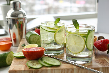 Preparation of chilled lime with cucumber punch homemade cocktail closeup