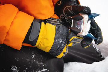 Setting up ski equipment, close-up of a hand for setting up and twisting ski boot bindings on a...