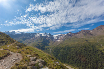 Panorama on the glaciers of the Palla Bianca massif seen from a path with a panoramic bench, Alto Adige - Sudtirol, Italy. Popular mountain for climbers and travel destination