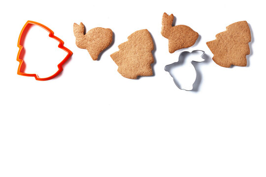Ready-made Christmas cookies in the form of a rabbit and a Christmas tree with cookie cutters isolated on a white background. copy space.