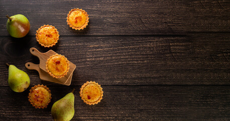 The image captures the essence of home baking with caramelized tarts and pears, ready to be served for a comforting dessert experience