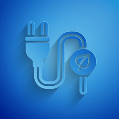 Paper cut Electric saving plug in leaf icon isolated on blue background. Save energy electricity. Environmental protection. Bio energy. Paper art style. Vector