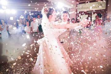 Beautiful wedding couple just married and dancing their first dance