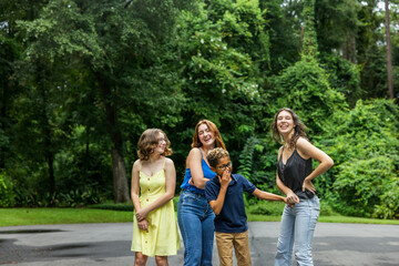 Four siblingss outside in the summer