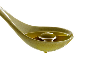 organic olive oil poured into the spoon