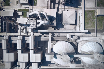 Top down aerial view of huge cement producing factory. Pipes, silos and other structures of industrial enterprise