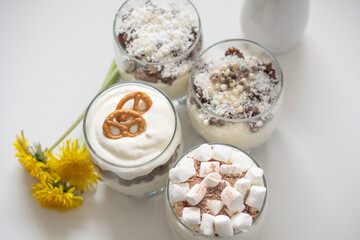 Fototapeta na wymiar Delicious sweet dessert with cream in a glass on a light background, a beautiful breakfast