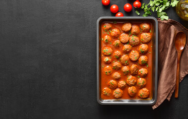 Meatballs with tomato sauce in baking dish