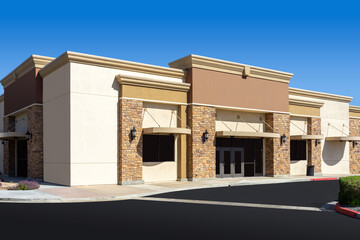 New commercial retail office building with blue sky - Powered by Adobe