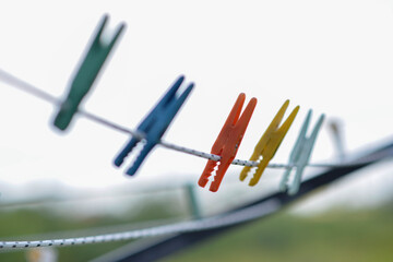 Clothespins in various colors on the wire outside