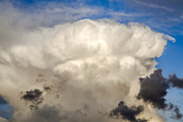 layered storm clouds, heavy rain clouds, sky before sunset spectacularly illuminated by sunlight,...